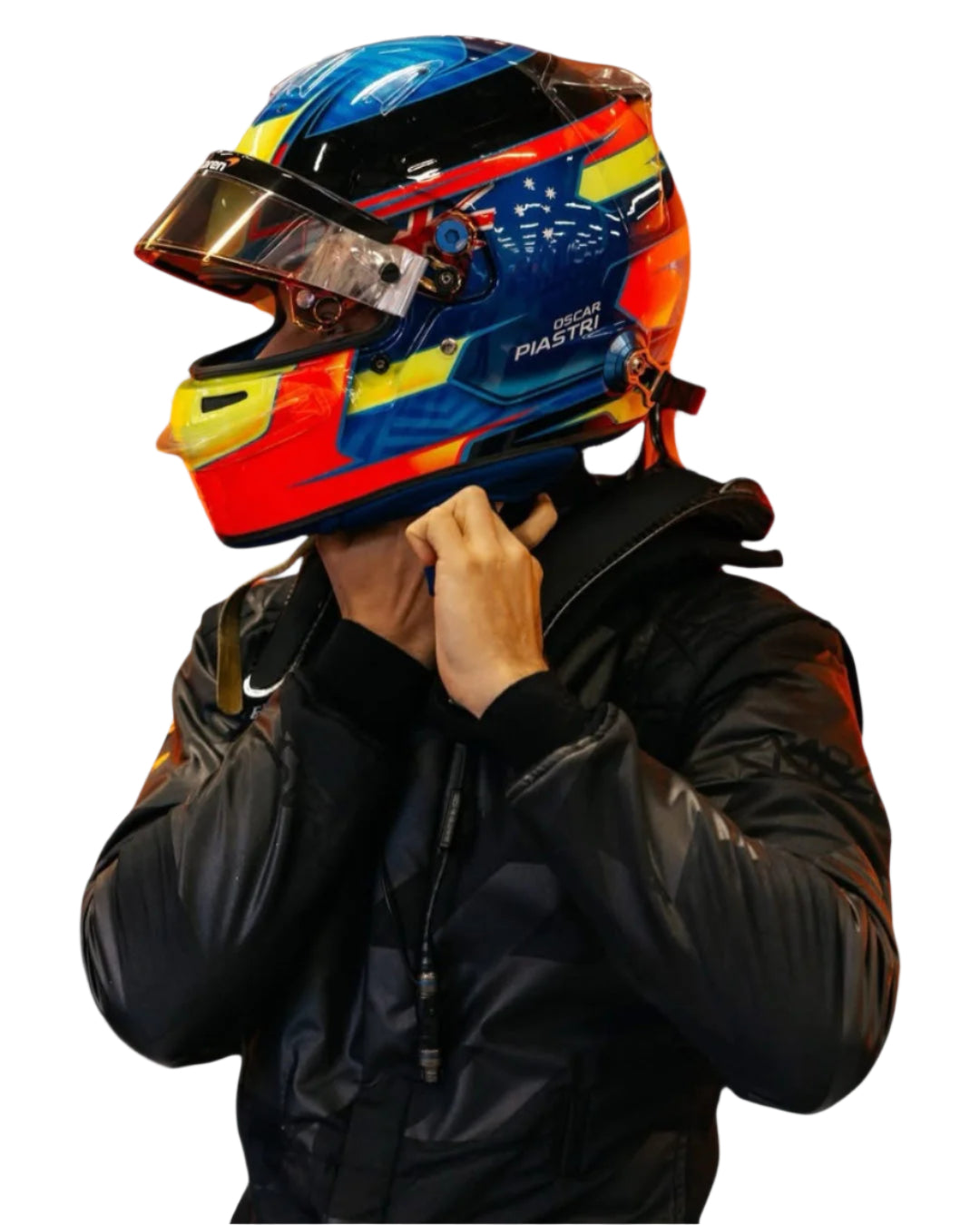 Endless Racegear model wearing 2025 Lando Norris McLaren race suit fastening a colorful racing helmet strap