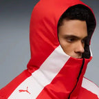 Reversible hooded racing jacket close-up, red hood with white diagonal stripe and Puma logo.