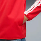 Red softshell jacket sleeve with white stripe trim and zip cuff detail