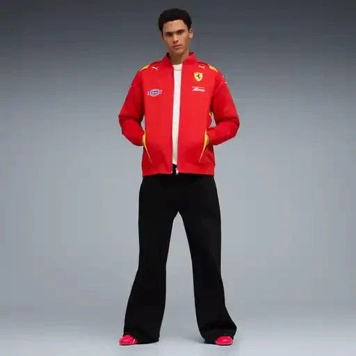 Red team jacket and black pants on model, front zipper and yellow trim visible
